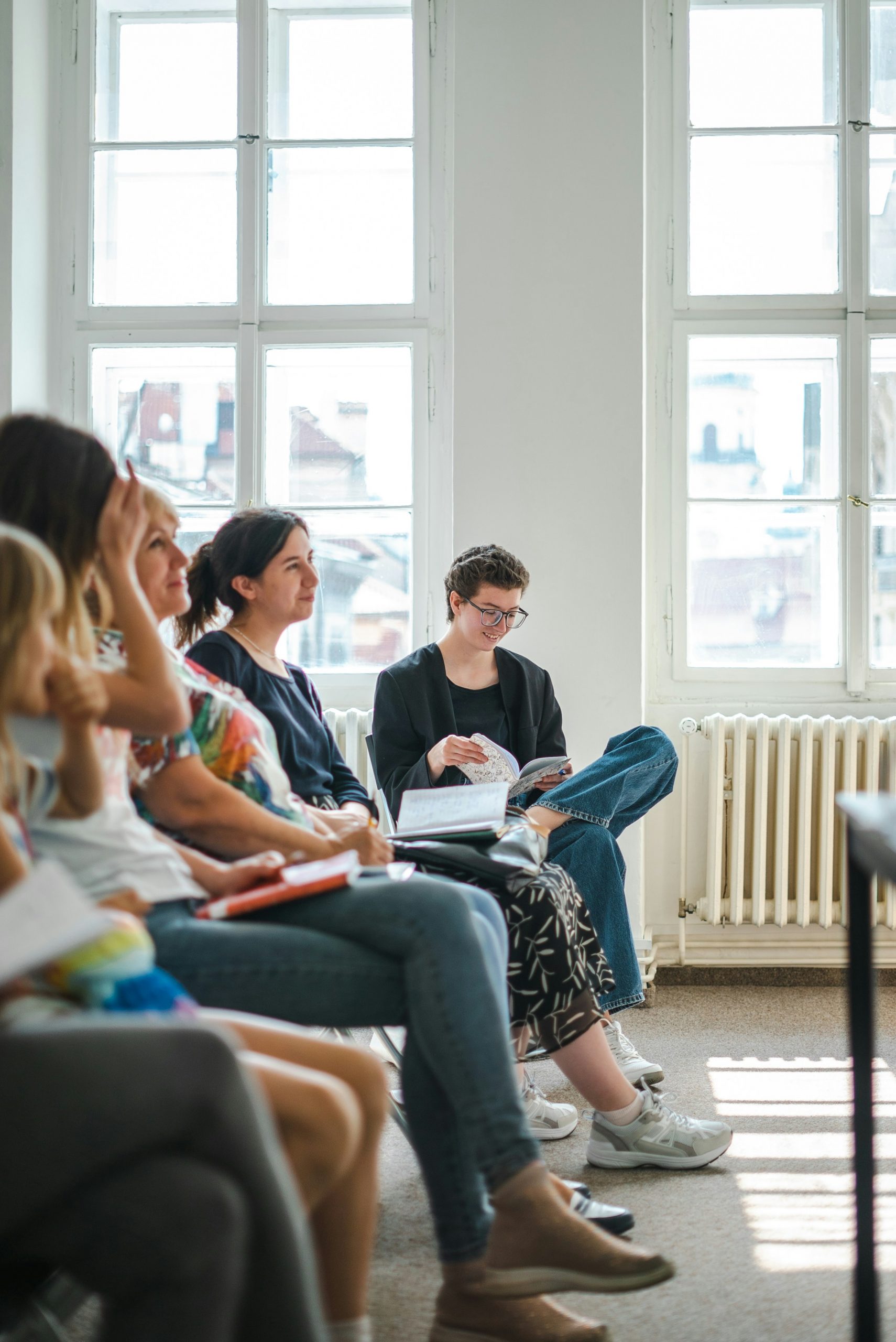 A reflective professional workshop space with seating arranged for group discussion